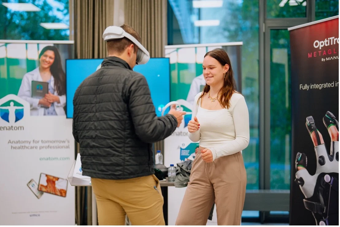 Man with VR headset talking to a woman