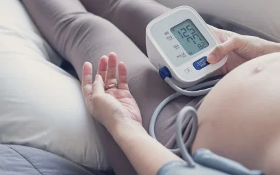 A pregnant woman wearing a monitor