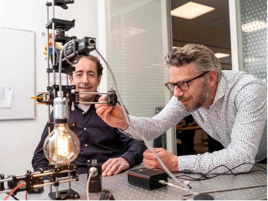 Two men working on a piece of equipment