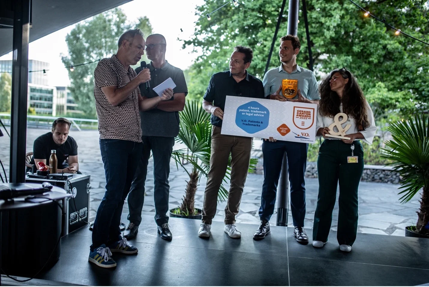 A group of people on stage winning an award