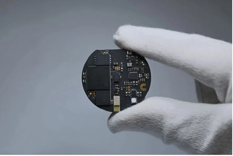 Computer sense held by a gloved hand