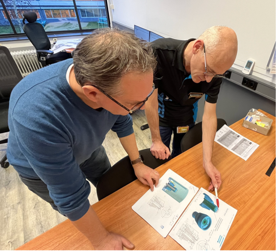 Two men looking at drawings