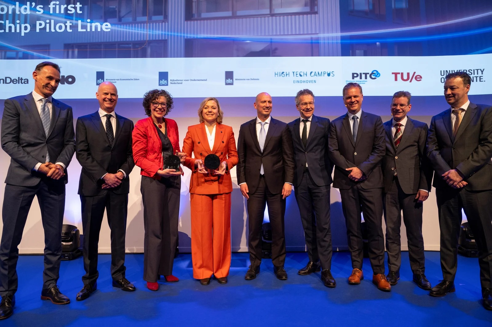 TNO, HTCE and government officials on stage at photonic chip factory construction launch.