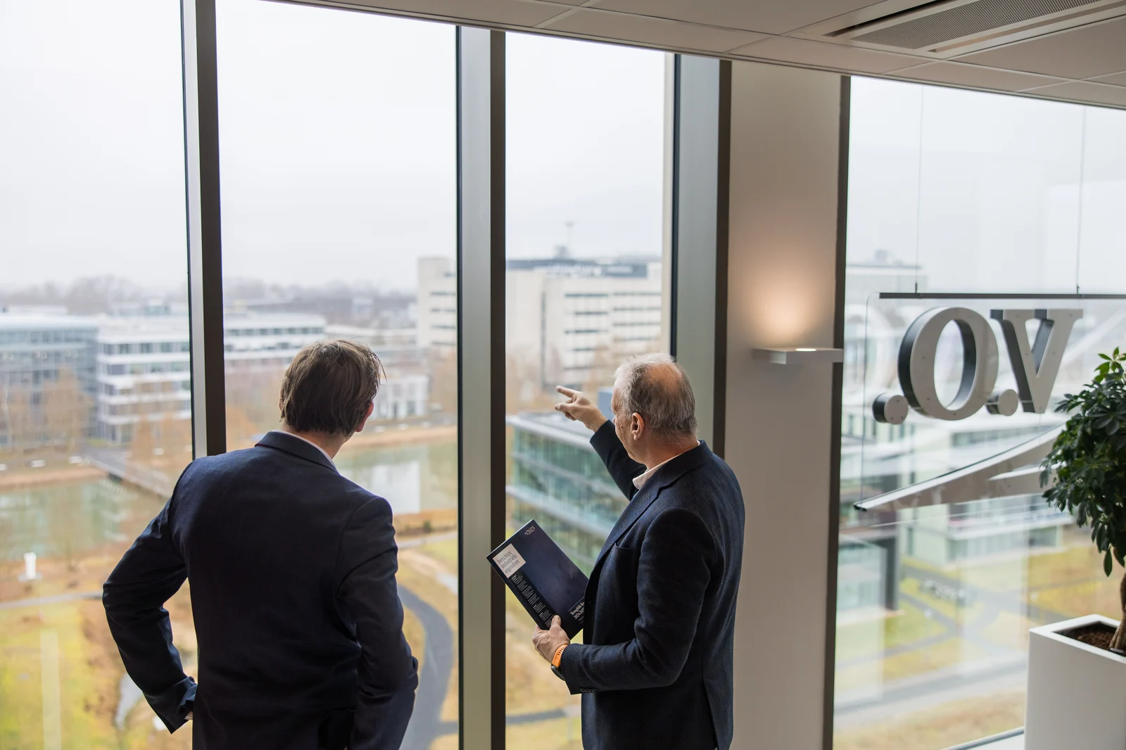 Two men looking at view from high building