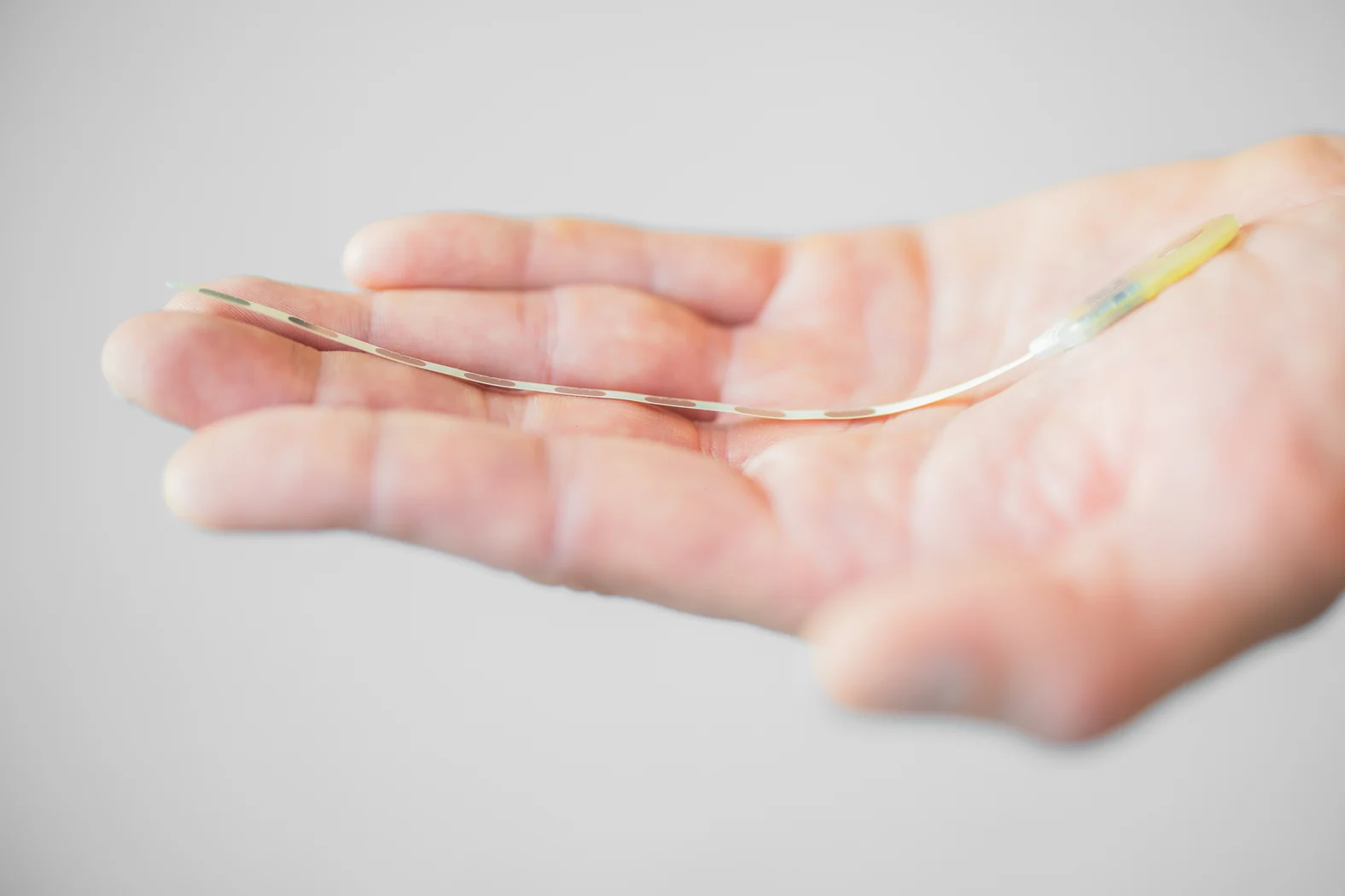 A hand holding an thin electronic device