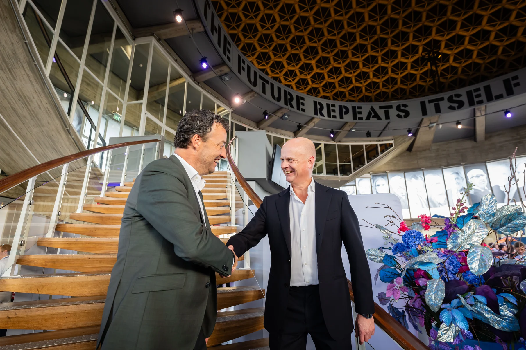 Ton van Mol and Otto van den Boogaard shake hands.