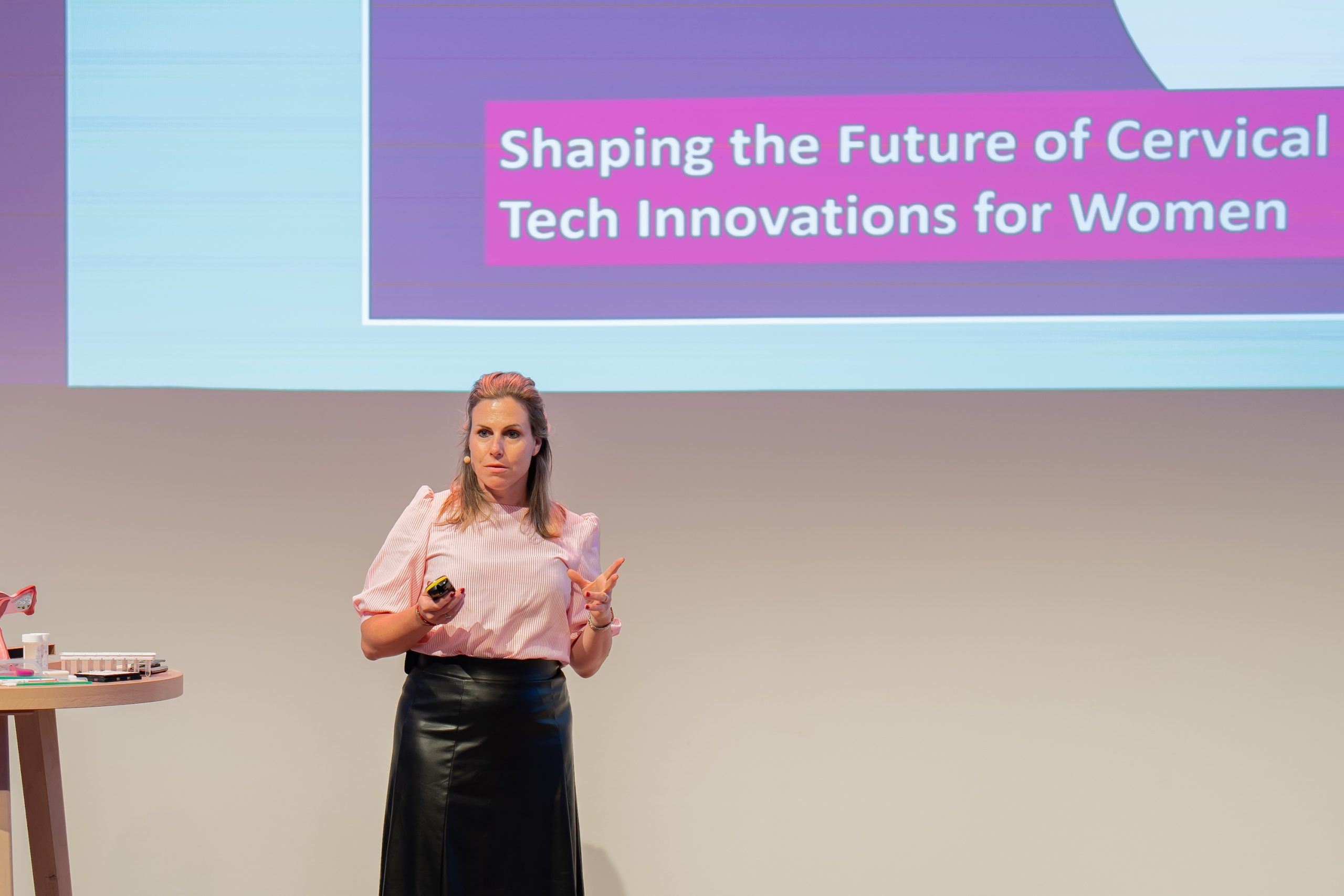 A woman on stage giving a presentation