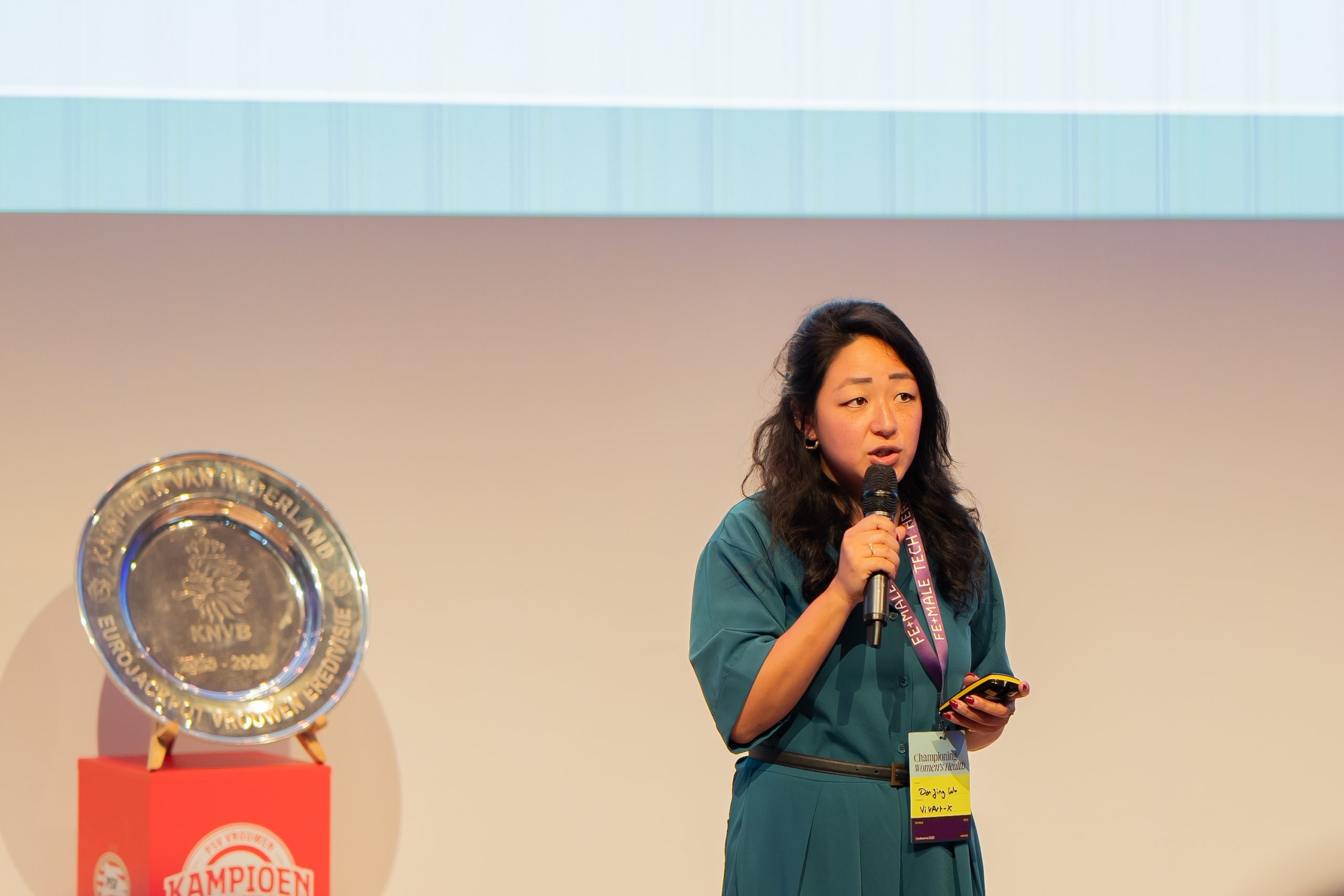 A woman speaks into a microphone