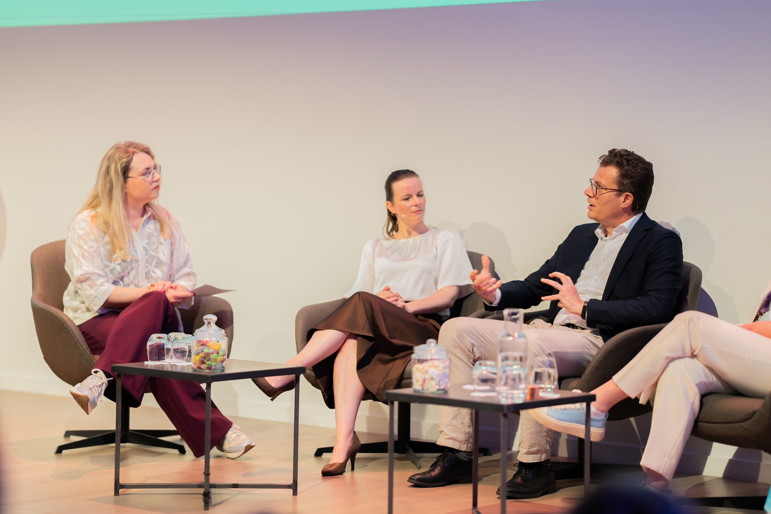 Two women and a man on a panel
