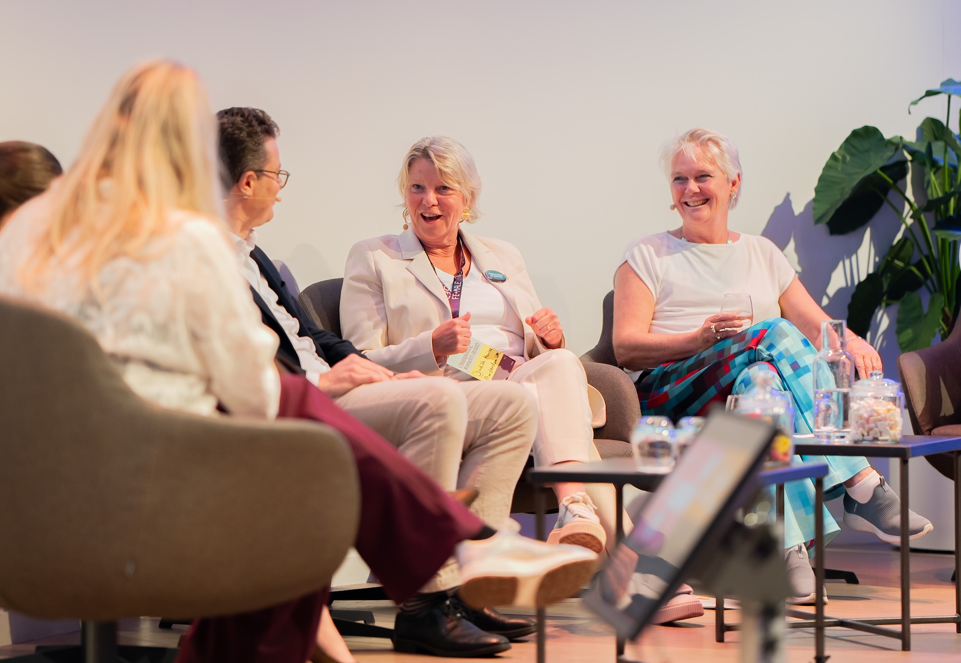 Two women talk in panel discussion