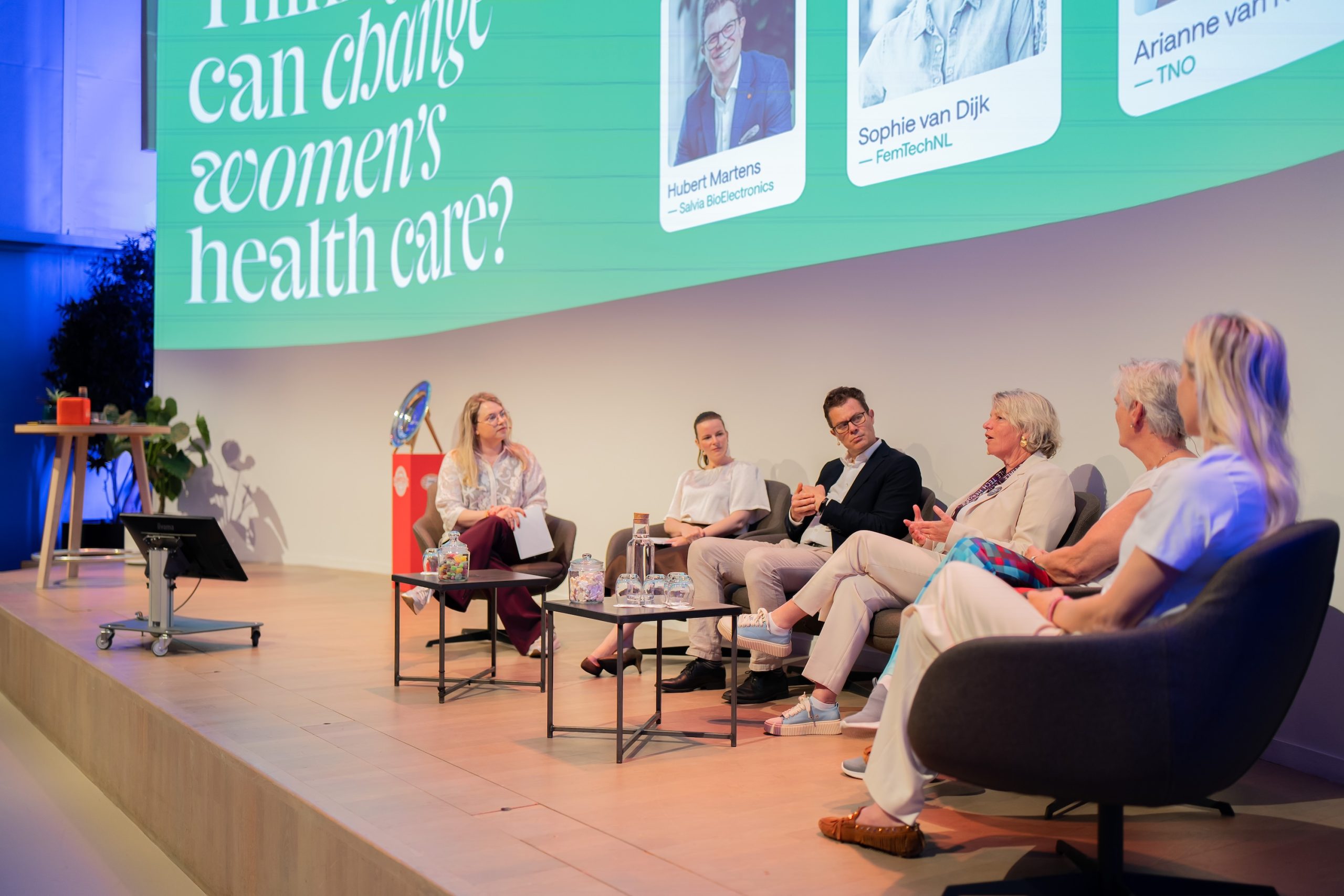 Panel discussion on stage with six panelists